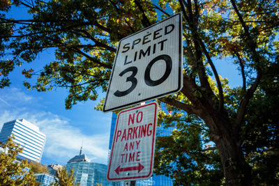 Low angle view of road sign against sky