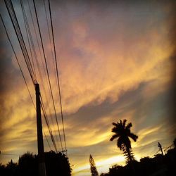 Low angle view of electricity pylon against sky