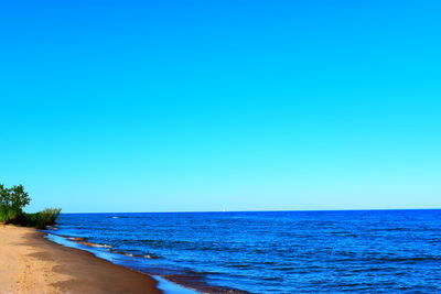 Scenic view of sea against clear blue sky