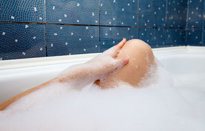 Midsection of woman in bathtub