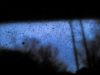 Close-up of window against sky at night