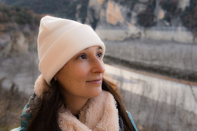 Portrait of young woman wearing hat