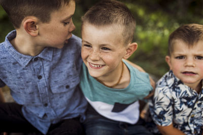 Happy brothers playing while sitting side by side