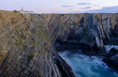 Panoramic view of rock formation in sea against sky