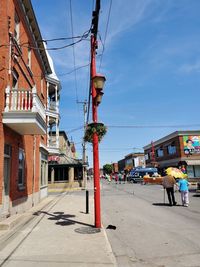 Street amidst buildings in city against sky