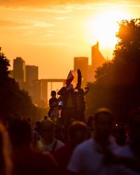 People in city during sunset