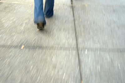 Low section of person standing in the dark