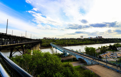 High angle view of train on bridge over river against sky