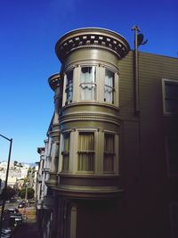 Low angle view of building against clear blue sky