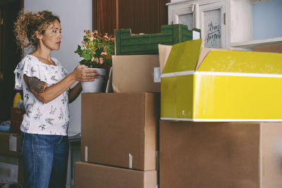 Rear view of woman holding christmas presents