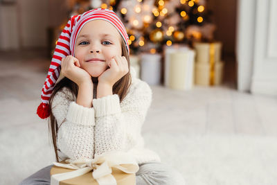 Portrait of cute girl sitting at home