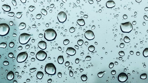 Full frame shot of raindrops on window