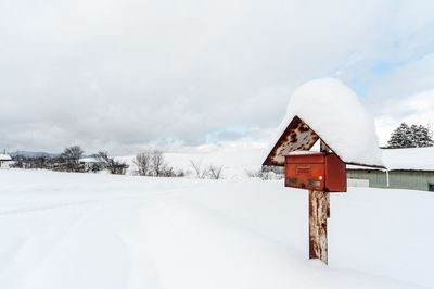 Snow on field against sky during winter