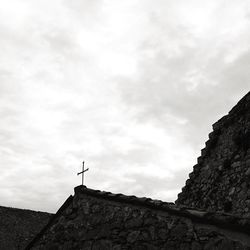 Low angle view of building against cloudy sky