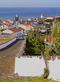 High angle view of buildings by sea against sky