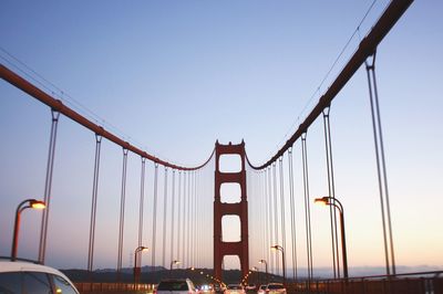 Low angle view of suspension bridge against clear sky