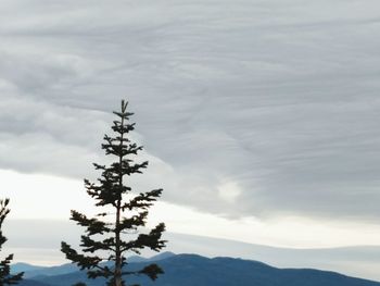 Low angle view of mountain against cloudy sky