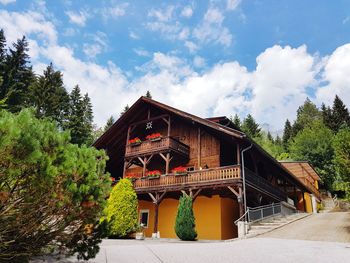 House by building against sky