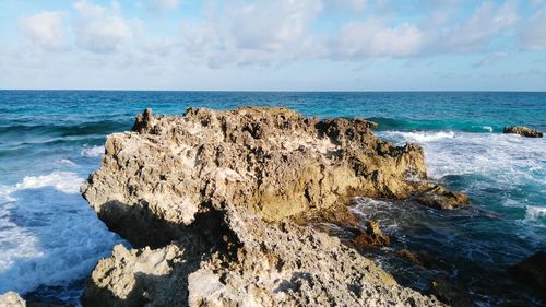 Rocks on beach against sky