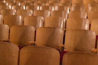 Full frame shot of wooden chairs at auditorium