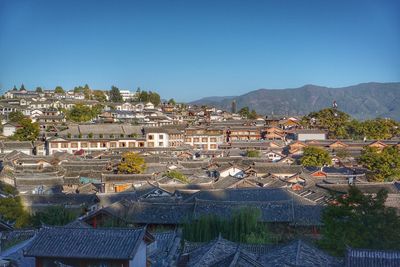 High angle view of townscape against clear blue sky