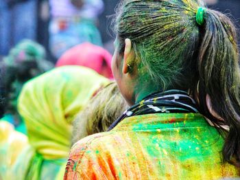 Rear view of woman enjoying holi