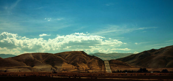 Scenic view of mountains against cloudy sky