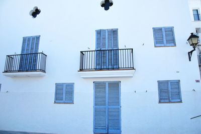 Low angle view of modern building against clear blue sky