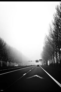 Road amidst trees against sky