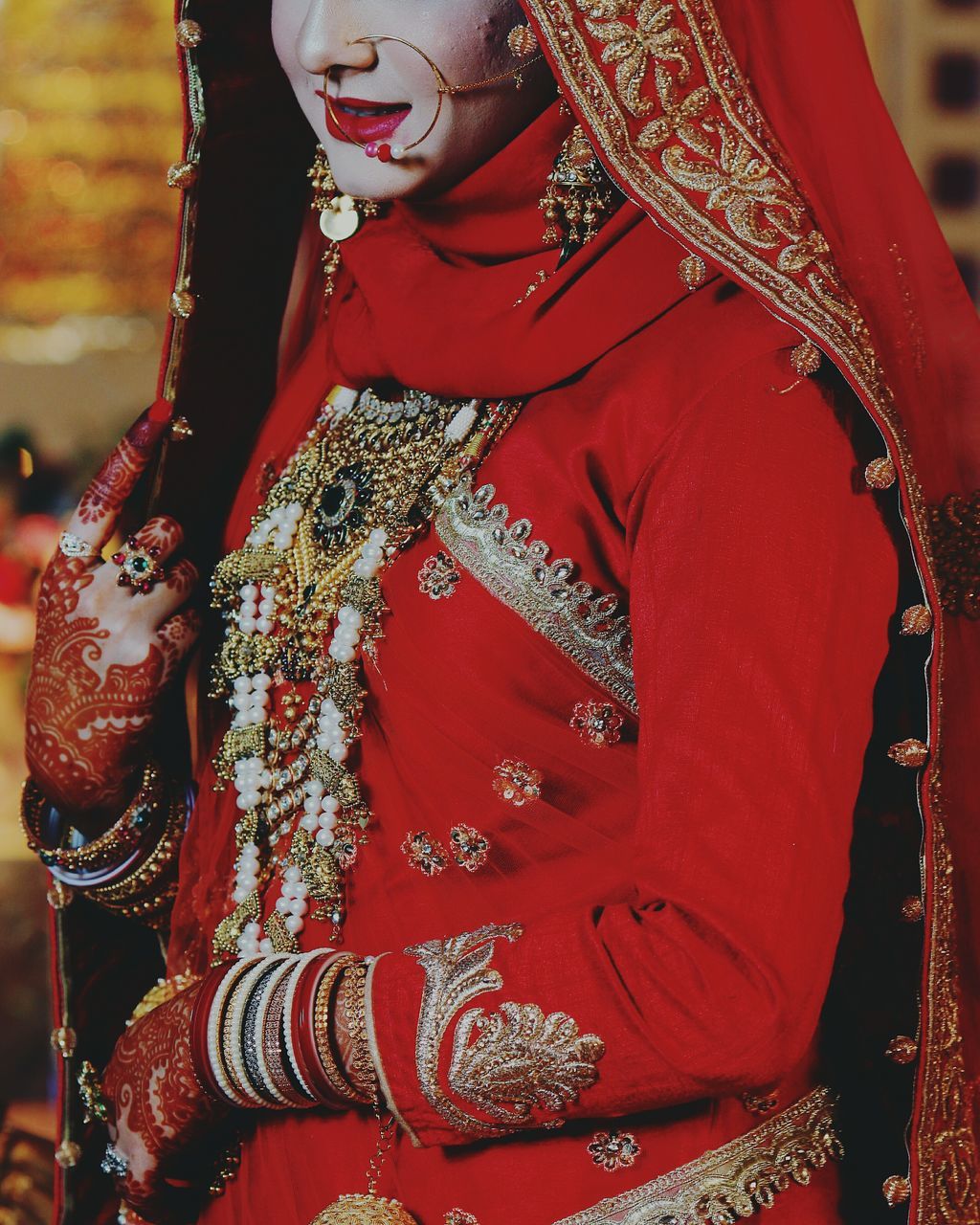 red, tradition, cultures, religion, celebration, spirituality, focus on foreground, person, lifestyles, indoors, midsection, traditional clothing, close-up, leisure activity, hanging, place of worship, temple - building