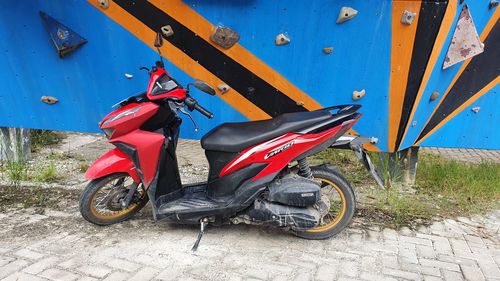 Motor scooter parked on road