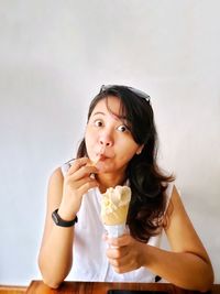 Portrait of a girl enjoying yummy cone ice cream.  