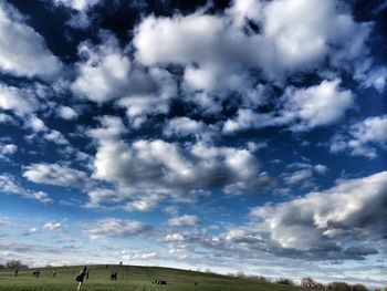 Scenic view of landscape against cloudy sky