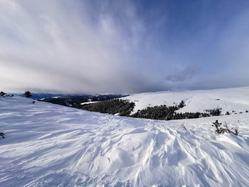 Badweather clouds coming up in the alps - scenic view of alpine winter landscape