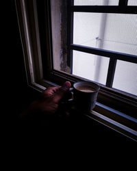 Cropped image of hand holding coffee cup