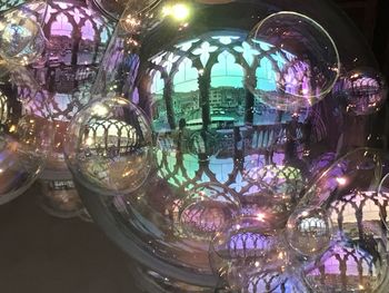 Close-up of illuminated lighting equipment in glass