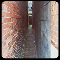 Walkway leading to brick wall