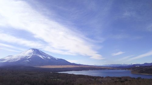 Scenic view of mountains against blue sky