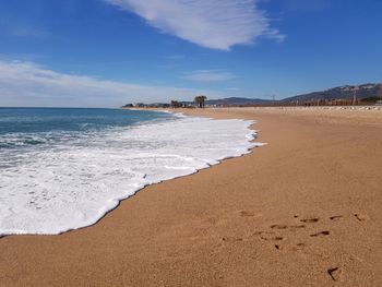 View of beach against cloudy sky