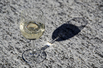 Close-up of drink on sand