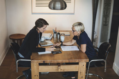 Female industrial designers using digital tablet at home office