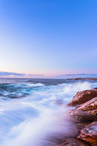 Scenic view of sea against clear sky during sunset