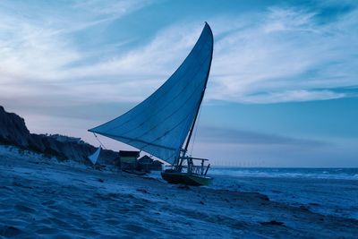 Sailboat in sea against sky