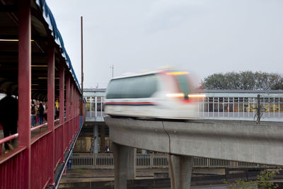 Train moving on bridge against sky
