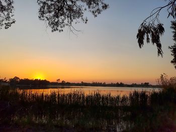 Scenic view of lake against sky during sunset