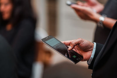 Midsection of woman using mobile phone