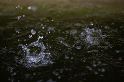 High angle view of raindrops on water