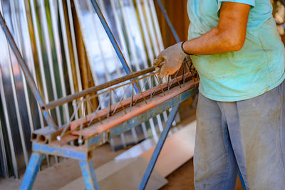 Side view of woman working on chair