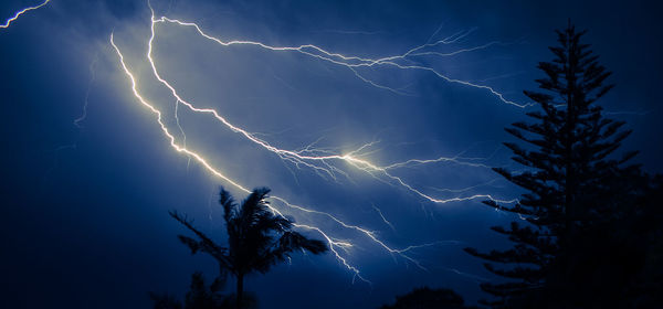 Low angle view of lightning in sky at night