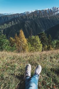 Low section of man standing on mountain